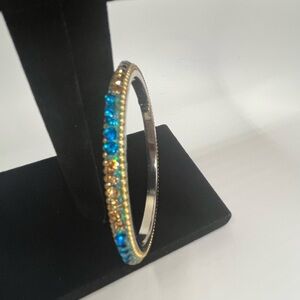 Stylish blue and gold crystal and rhinestone metal bangle bracelet.